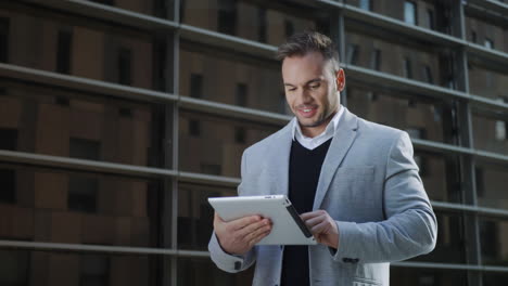 Businessman browsing internet on digital tablet in city. Manager using touchpad