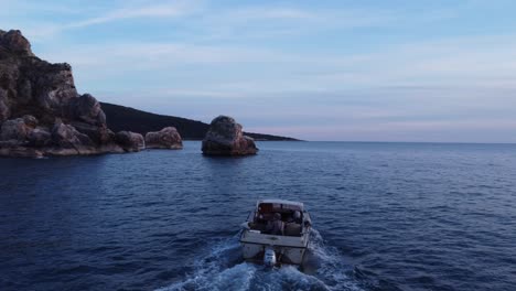 drone follows a boat in the ocean