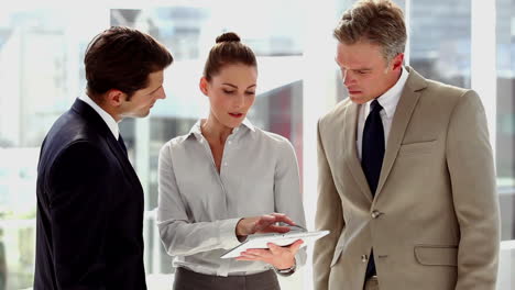 Business-people-using-tablet-together