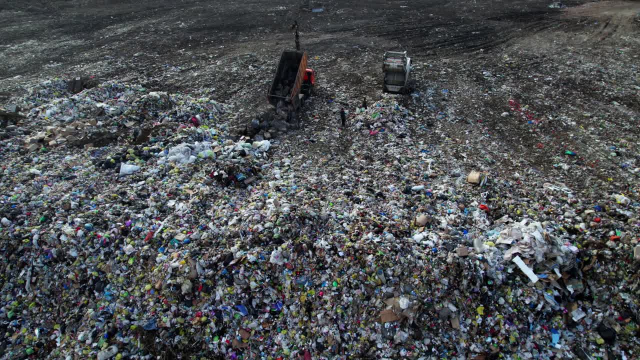 Garbage Dumpsite with Trucks