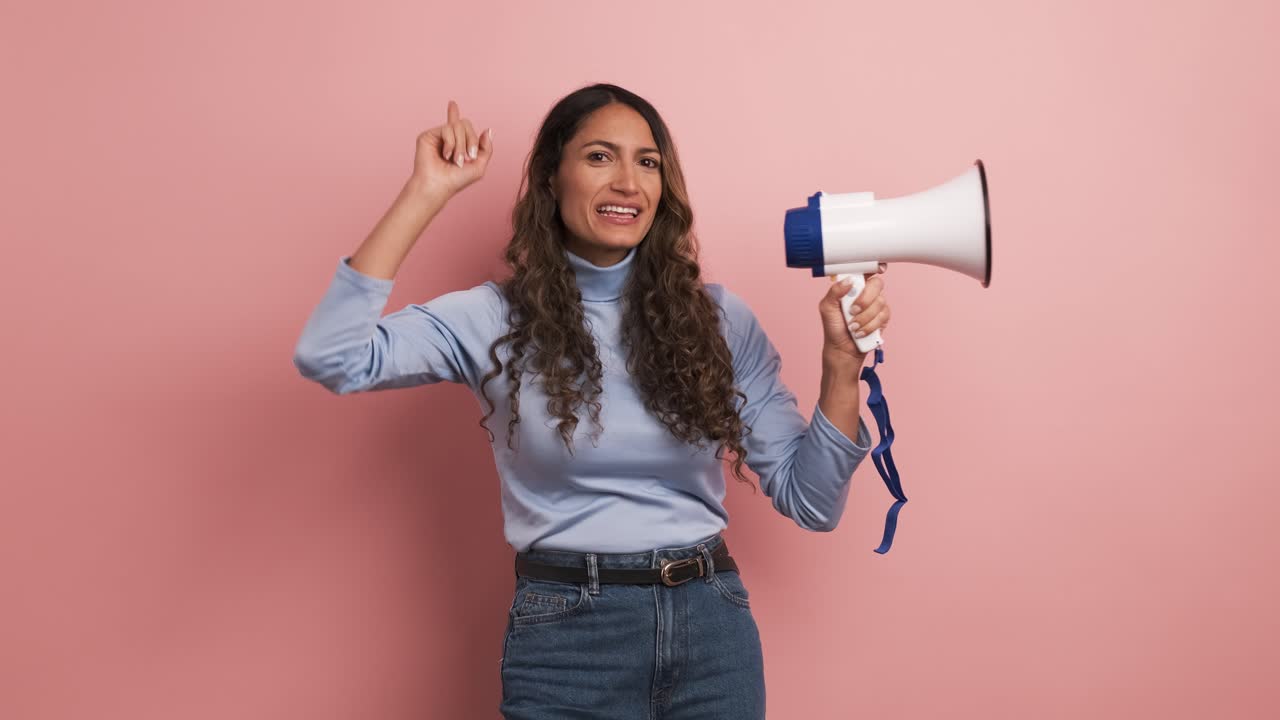 Colombian woman using a loudspeaker and yelling positive