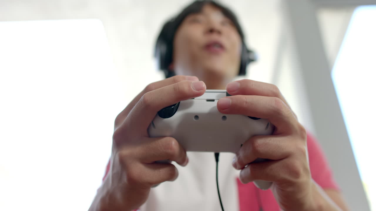 un adolescente asiático se centró en los juegos en casa.
