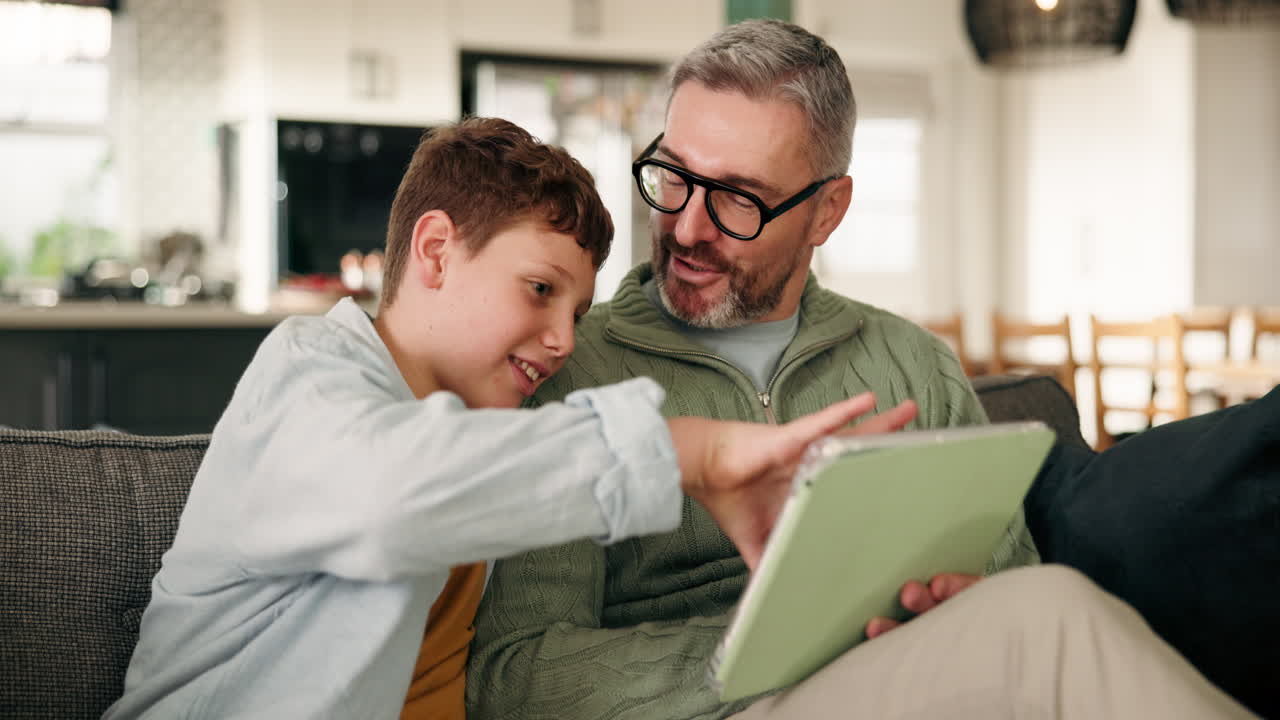 Father and Son Using Tablet at Home