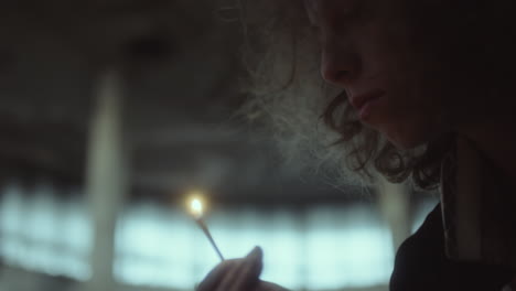 close-up of a person holding a lit match