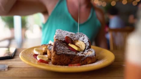 slowmotion shot of a guy dripping honey over delicious frenchtoast