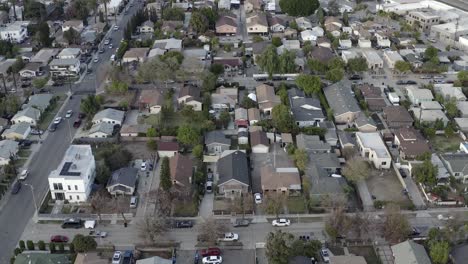 rising aerial view above los angeles suburban residential district neighborhood rooftops