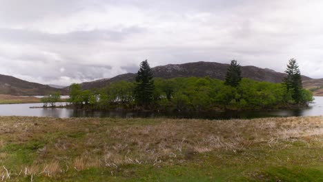 Cinematic-timelapse-of-scottish-lake-with-misty-clouds-in-background