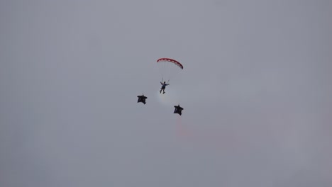 the skydiver flies through the air together with the sky diver and then the sky divers break away from the formation. taken at the air show called airpower 2024
