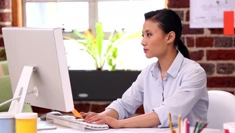 Pretty-designer-working-at-her-desk-on-computer