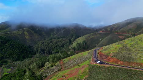 Drone-shot-of-cars-parked-at-a-view-point-on-the-side-of-California's-scenic-highway