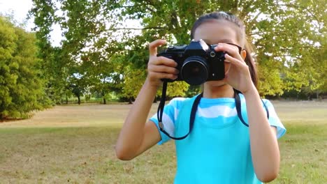 girl clicking a photograph from camera