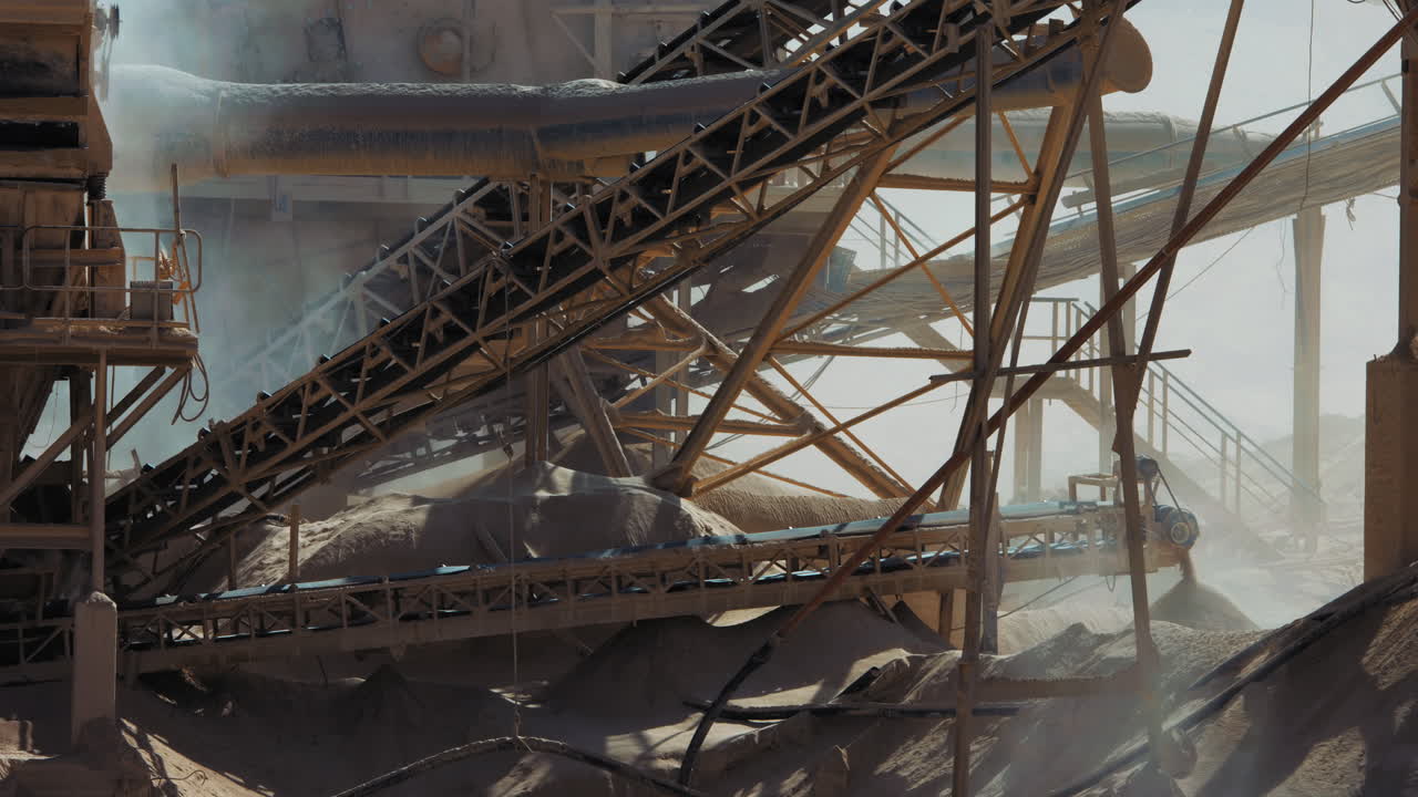 Industrial sand mining. Stone crusher (rock stone crushing machines) belt is rolling, 4K footage