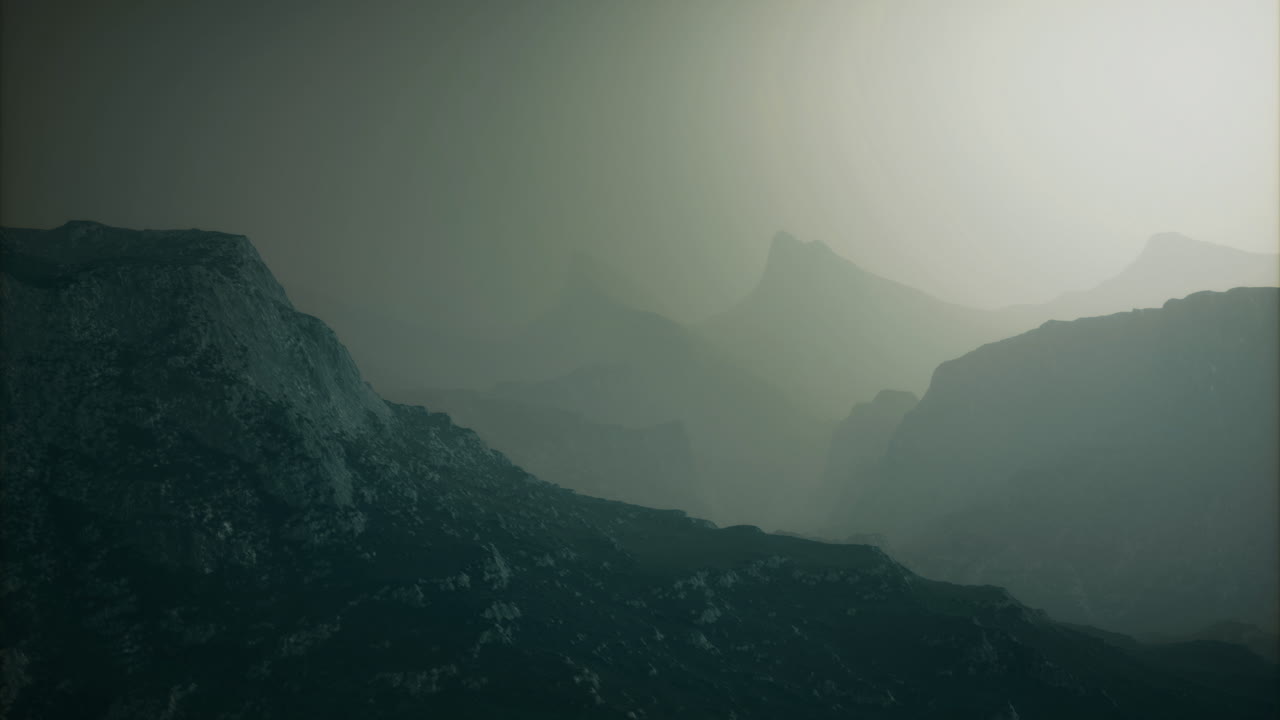 Mysterious mountains shrouded in fog during early morning hours