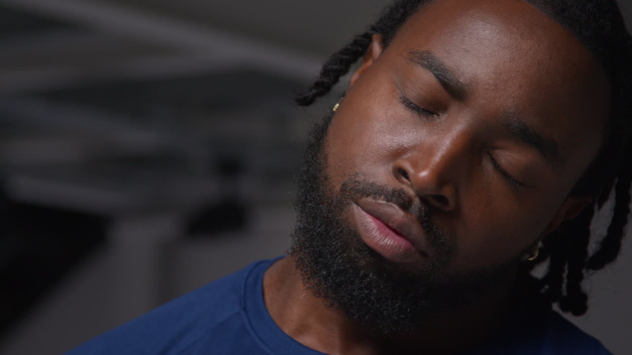Close Up Of Male Athlete With Eyes Closed Training In Gym Stretching And Warming Up Preparing For Sports Event