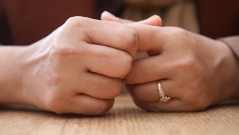 closeup of a woman's hands with a ring on her finger