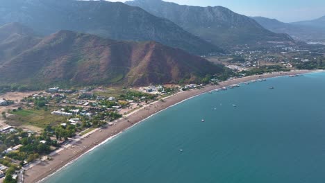 aerial view of a coastal town with beach and mountains