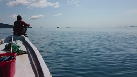 Fisherman-enjoying-ride-on-a-boat-on-a-sunny-day-with-calm-and-clear-weather