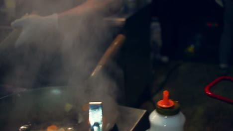 wok cooking. cooking asian food. chef cooking vegetables in wok pan