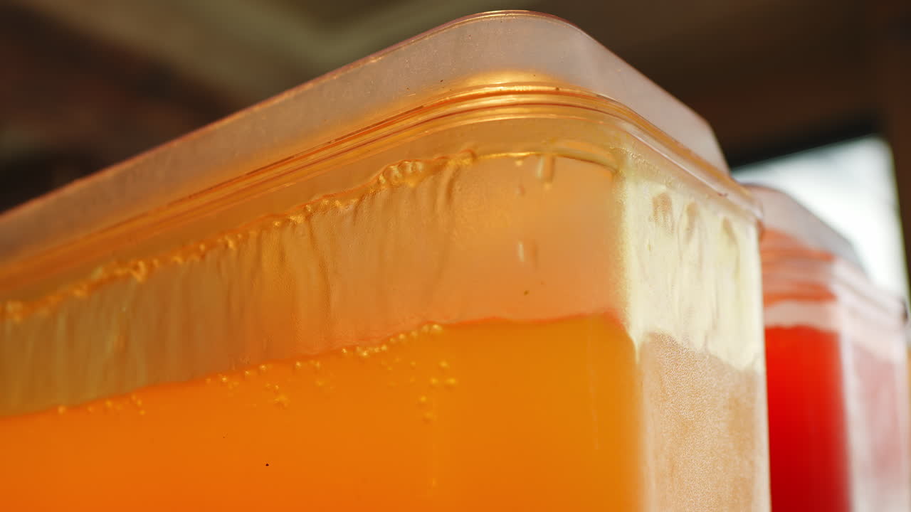 Golden juice container with foam layer and condensation on wall