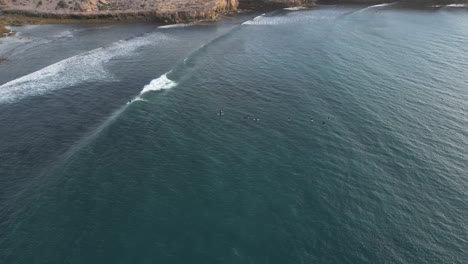 Birds-eye-view-over-cactus-beach-and-the-surfers-on-the-water