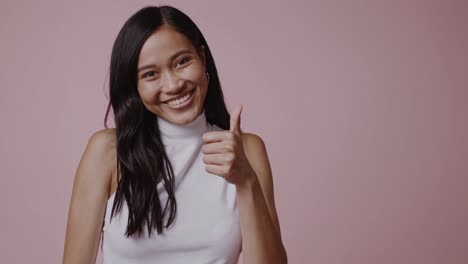 smiling woman giving a thumbs up