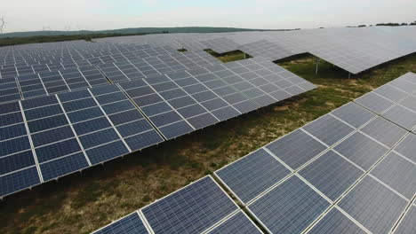 Low-aerial-view-industrial-Solar-Energy-Farm-cloudy-day