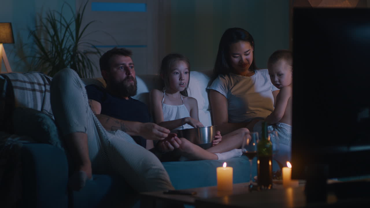 Family Watching TV at Night