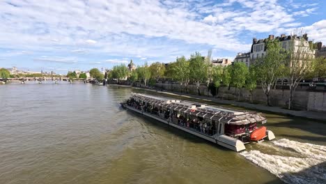 boat cruising along seine river in paris