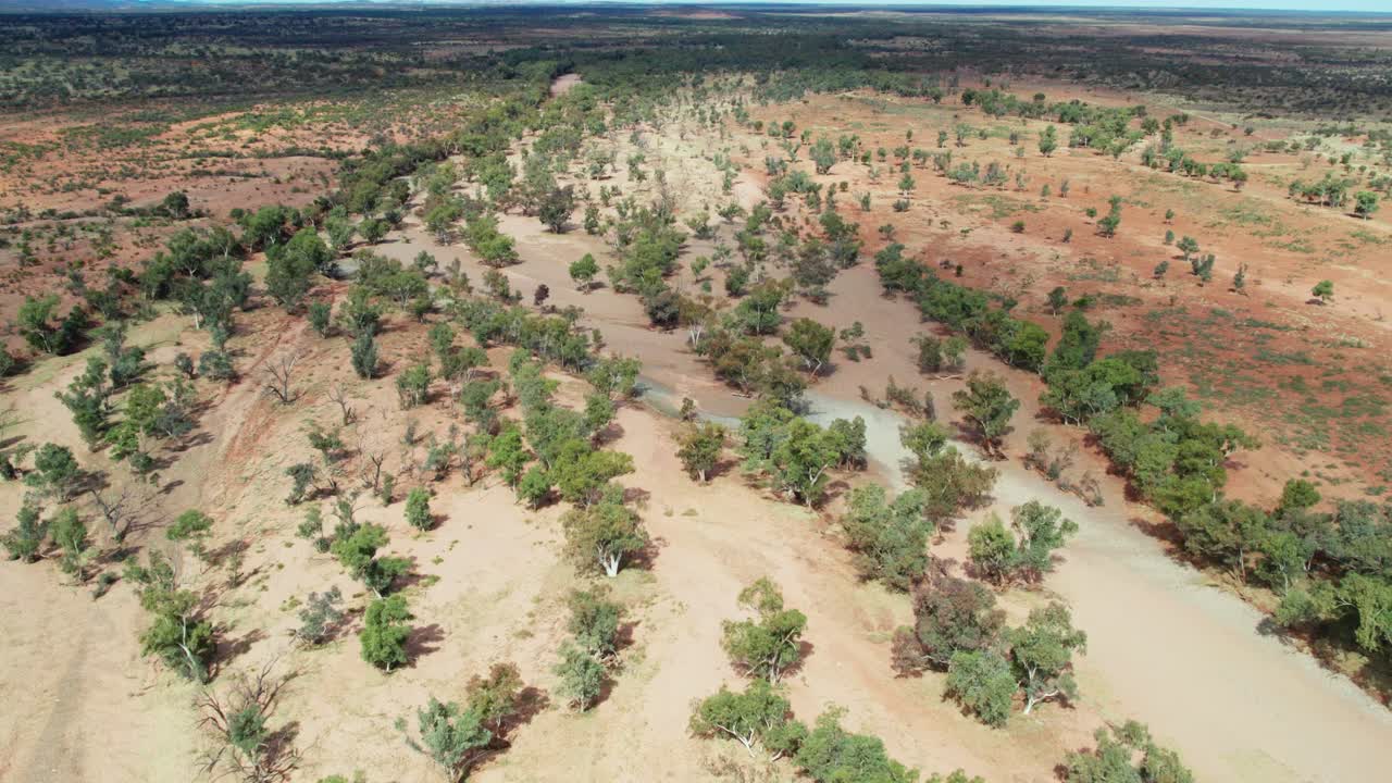 Low aerial footage of the dry Hugh River near the Stuart Highway. Northern Territory, Australia. August 2022.