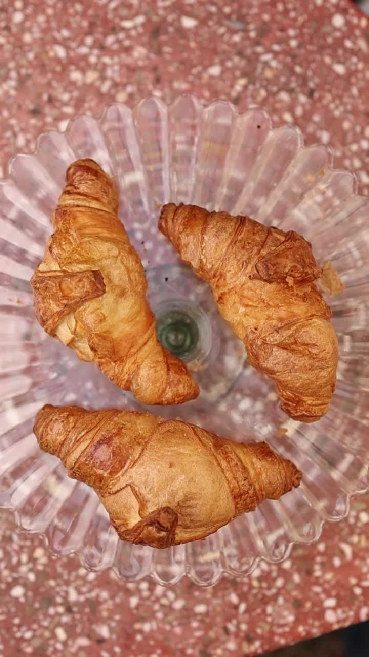 Three Golden Croissants on a Glass Plate, Top View