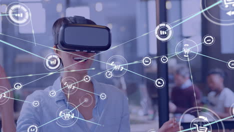 Animation of network of connections with icons over happy caucasian businesswoman using vr headset