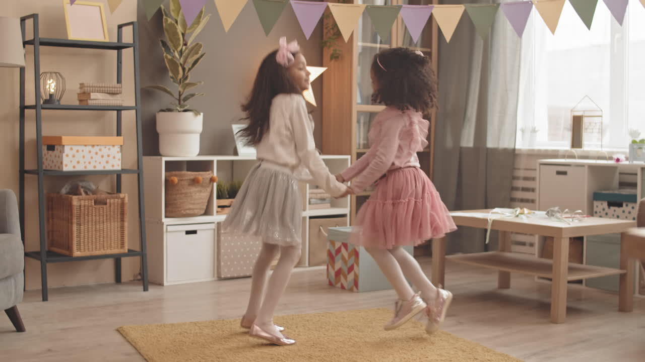 Little Sisters Jumping in Living Room