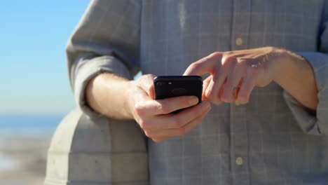 mid section of man using mobile phone on promenade 4k