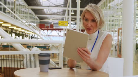 businesswoman using a tablet in a conference foyer