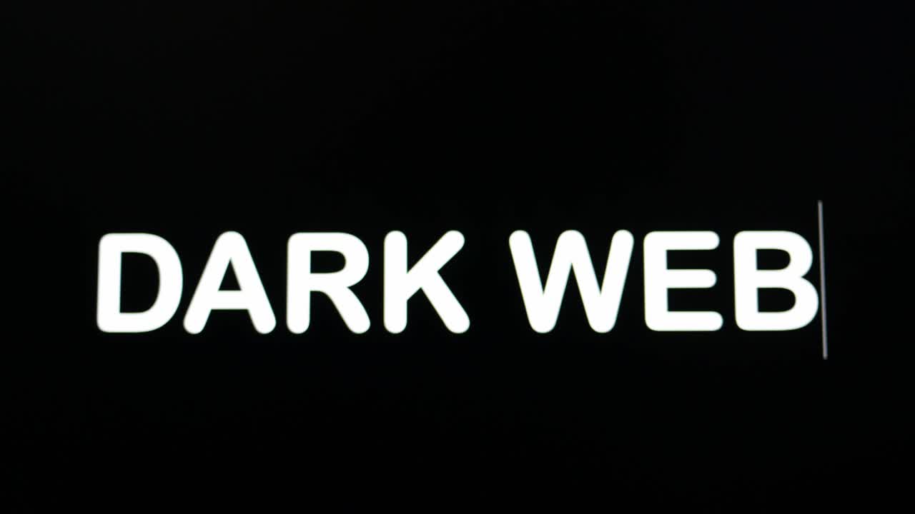 Close up of DARK WEB being typed into computer monitor screen with blinking cursor on black background copy space