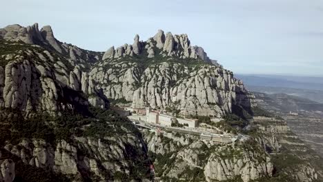 aerial montserrat mountain range with santa maria abbey monastery in spain