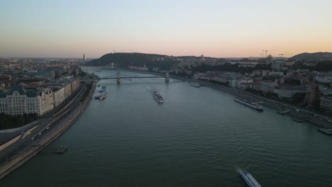 beautiful drone flight above the danube river in budapest, hungary at sunset