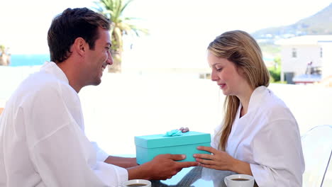 Handsome-man-surprising-his-girlfriend-with-a-gift