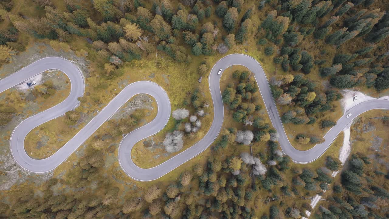 4K Aerial cinematic shot of the Dolomites’ famous Snake Road with vibrant fall colours. Italy_02