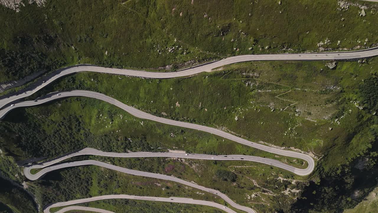 vista aérea de arriba hacia abajo de las carreteras serpentinas que serpentean a través de la región montañosa cerca del lago totensee en obergoms, suiza, destacando la compleja ruta a través del escarpado paisaje alpino