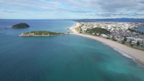 aerial view of mount maunganui coastline with beach, ocean, and islands