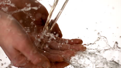 woman washing her hands with water