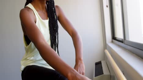 woman stretching her leg at barre 4k