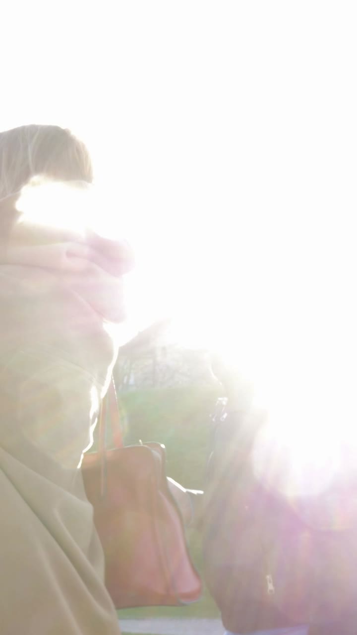 People walking outdoors on a sunny day