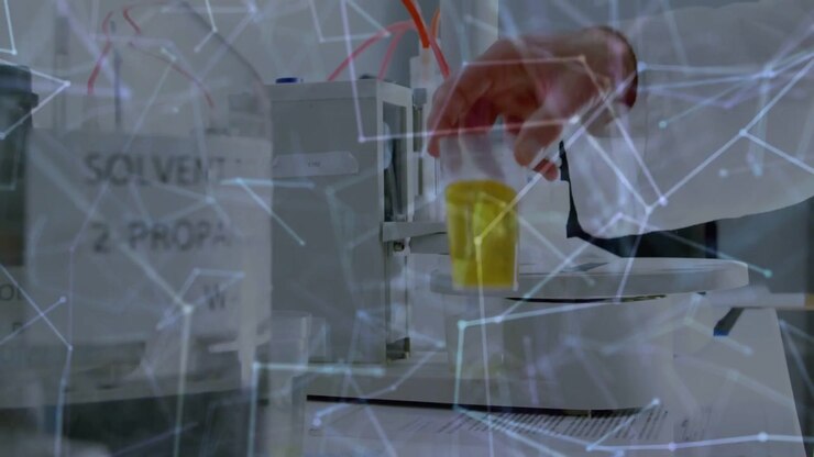 Senior tech reaching in, placing cup under autosampler for lab analysis, overlay tracking motion