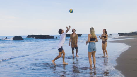 friends playing beach volleyball.