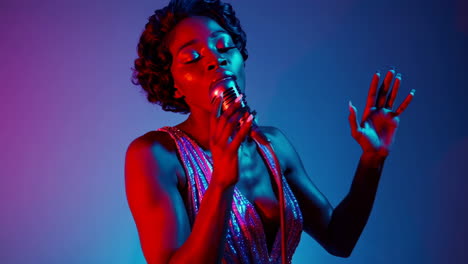 woman singing with vintage microphone under neon neon lights