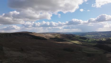 drone footage flying over dark peak district moorland with a cloudy sky
