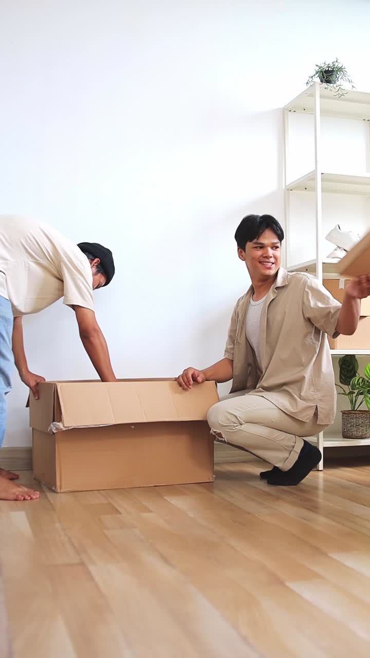 Two young entrepreneur unpacking boxes preparing for online clothing store