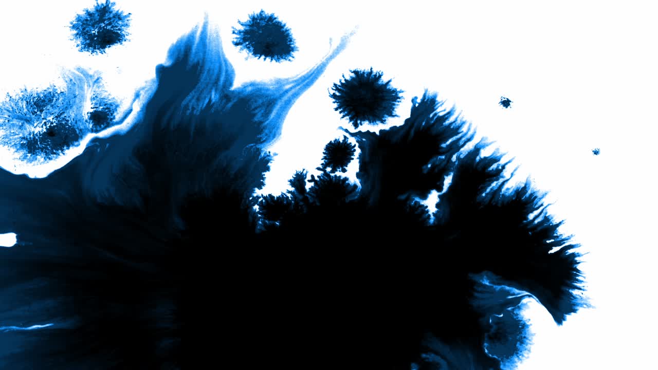 Splashes and spots of blue cobalt ink spreading on white background